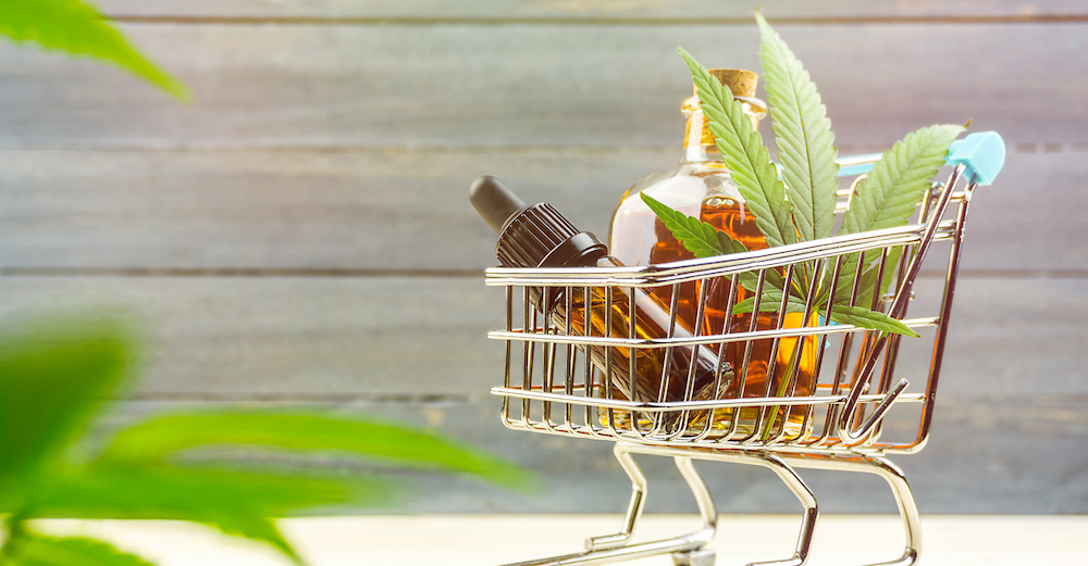 CBD products in a tiny shopping cart showing CBD marketing compliance