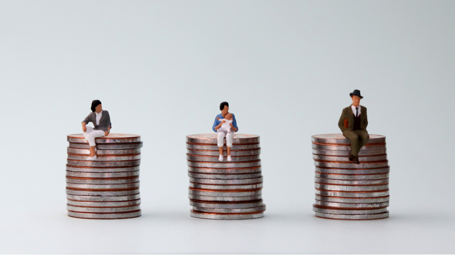 Image of 3 equal piles of coins with figurines sitting on top of them, one has brown skin, one is a mother, and one is a white male to demonstrate how effective pay audits can result in equal pay.
