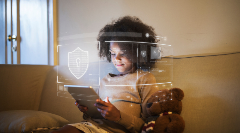 Photograph of a young child online using a tablet with a holographic image of a lock to show verifiable parental consent COPPA requirement